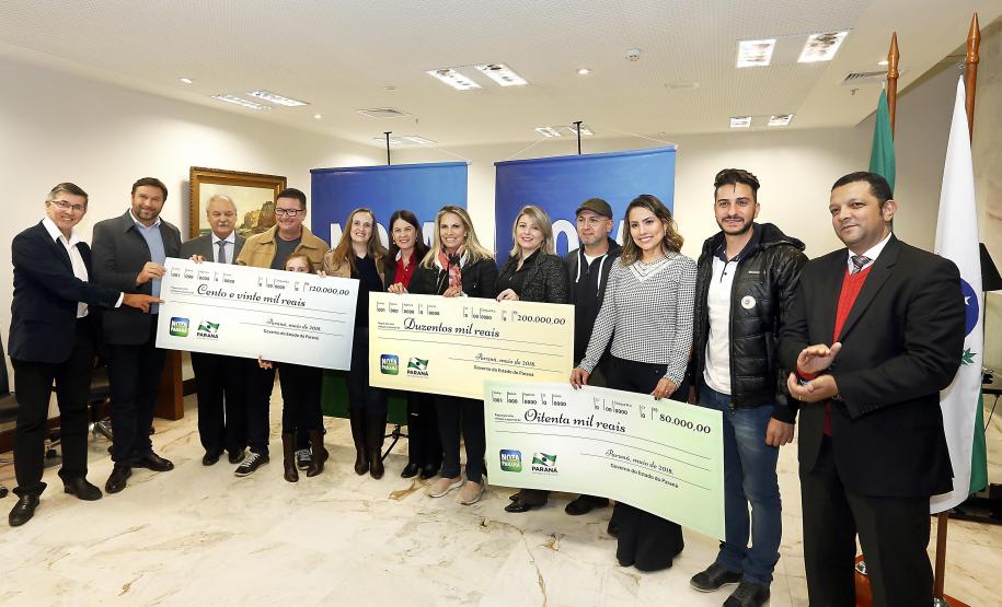 Três mães são as ganhadoras de maio do Nota Paraná No mês de maio, três mães foram as ganhadoras dos maiores prêmios do 30 sorteio do Programa Nota Paraná. Elas são de Colombo, Maringá e Piraí do Sul e foram premiadas com os valores de R$ 200 mil, R$ 120 mil e R$ 80 mil. Os prêmios foram entregues pela governadora Cida Borghetti nesta quarta, no Palácio Iguacu.
